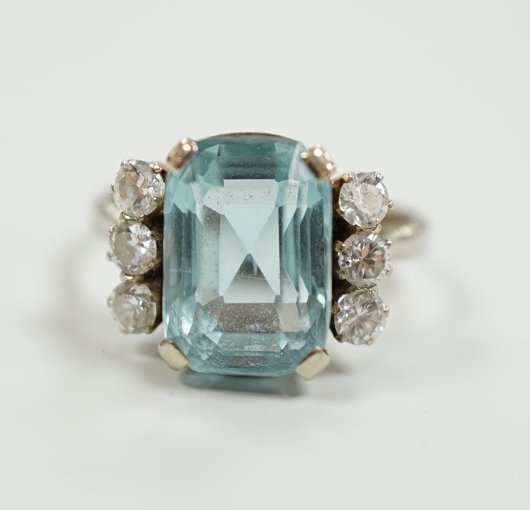 A white metal and single stone emerald cut aquamarine and six stone diamond set dress ring, size P/Q, gross weight 4.2 grams.